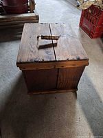 Top view showing split-top lid, wooden handle, metal hardware and overall finish