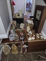Group shot of angel figurines, carolers, village houses displayed on steps