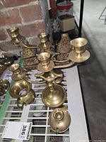 Multi-arm candelabrum, brass taper holders, trinket boxes grouped on shelf