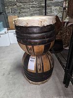 Full view of hourglass drum showing both heads and carved bands