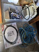 Overview showing heater, lockset package, hardware bin, address plaque kit, and coiled extension cord