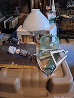 Group of glass shades, lantern frame, mounting plate with CFL bulb