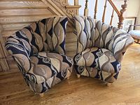 Front view of both fan-back chairs showing upholstery pattern and overall shape