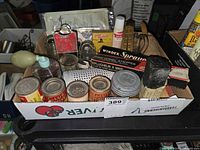 Overall lot in box showing spice tins, gadgets and utensils
