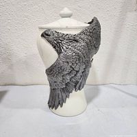 front view of marble urn with pewter eagle head and wings