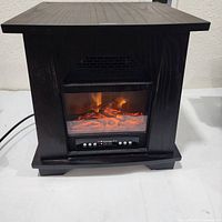 Front view of Konwin electric fireplace heater showing faux flames