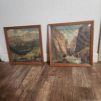Both framed railroad prints side by side on floor