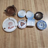 Group shot of all eight ashtrays and dishes on countertop
