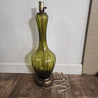 Full view of green blown glass lamp showing shape and height