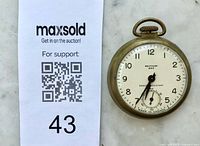 Watch front next to auction tag