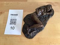 Bronze sculpture with MaxSold card for scale