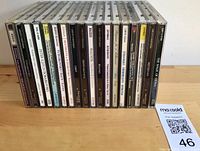 All 18 CD spines visible to show quantity and titles