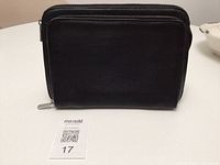 Front view of black leather clutch wallet