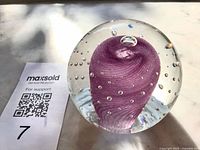 Oblique view showing purple swirl center and bubbles