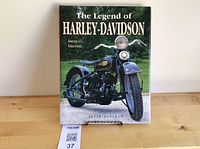 Front cover of Harley-Davidson coffee table book on stand