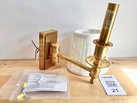 Brass sconce arm, backplate, white shade, wiring and hardware laid out