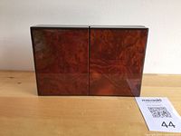 Front view closed lacquered burl-finish jewellery box