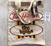 Front view of tote bag showing graphics and label