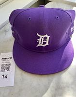Front view of purple Detroit Tigers New Era 59FIFTY cap with lot card