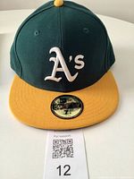 Front view of Oakland A's 59FIFTY cap showing crown, visor, stickers