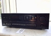 Front angled view of Pioneer SX-311R receiver showing controls and chip on bottom left casing