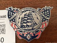 Front view of belt buckle showing full design and measurements card