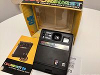 Front view of Kodak Colorburst 50 camera with manual and box