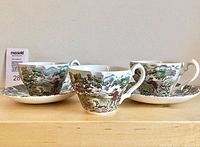Three cups and two saucers showing full pattern