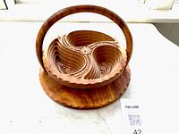 Basket opened showing carved interior and handle