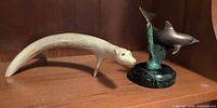 Bronze dolphin figurine and carved bear together