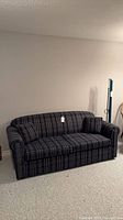 Front view of navy plaid sofa bed