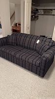 Full view of navy plaid sofa bed