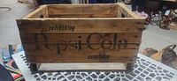 Overall view of crate showing Pepsi Cola graphic on long side.