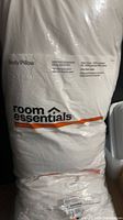 Front of packaged Room Essentials body pillow with label visible