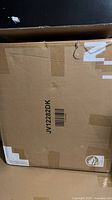 Sealed cardboard shipping box labelled JV12282DK