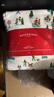 Front of sealed Wondershop flannel sheet set showing brand band and festive print