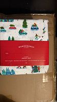 Front view of packaged sheet set showing red Wondershop label and holiday print