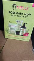 Front of sealed Mielle Rosemary Mint Root Rescue Kit box showing contents