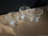 Three of the clear double-wall sculpted glasses on table