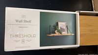 Front of Threshold wall shelf retail box showing product image and branding