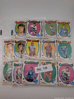 Fronts of 12 cards in plastic sheet showing Rangers, Canucks, Sabres, Golden Seals, Red Wings, Canadiens, Blues and others