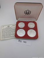 Closed presentation case with four coins displayed