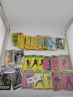 Stack of yellow-border ESB cards, several magenta/green character stickers, two modern Star Wars cards