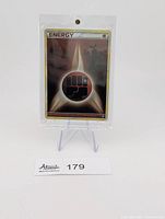 Front view of sleeved holographic Fighting Energy card on display