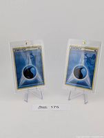 Front view of both Water Energy cards in plastic cases on stands