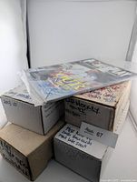 Stack showing three labeled boxes of hockey cards and a Powerplay magazine on top