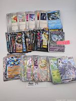 Group of Japanese Pokémon EX, V and Poké Ball cards laid out