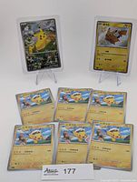 Two key cards on stands and five scene cards laid flat