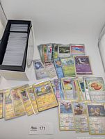 Box of approximately 400 reverse holo Pokémon cards with several cards spread out
