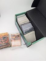 Open deck box with sleeved cards, sealed Time Spiral pack and shrink-wrapped deck visible